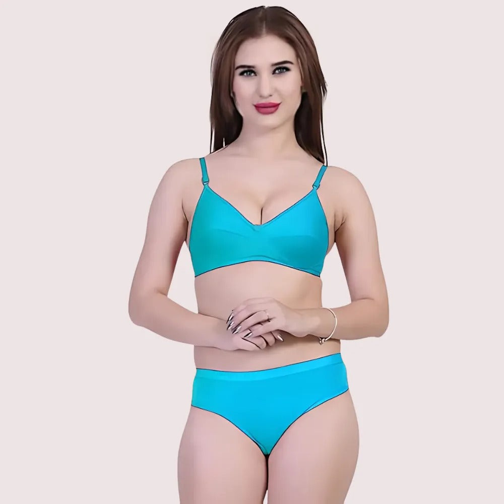 Woman wearing a blue bikini set on a light pink background