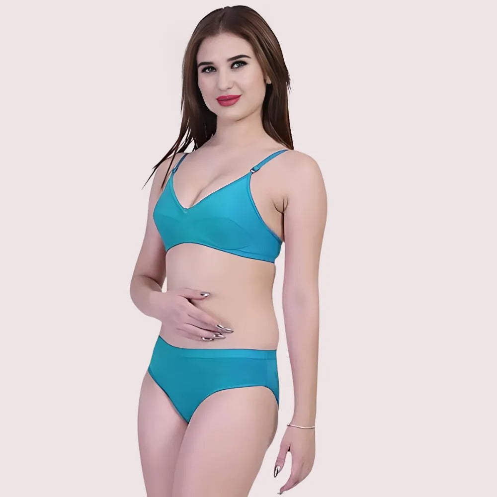 Woman wearing a blue bikini set on a light pink background